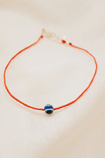 protective red string bracelet with silver evil eye