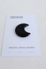 Crescent moon shaped obsidian stone