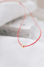Adjustable red string luck bracelet with gold bead